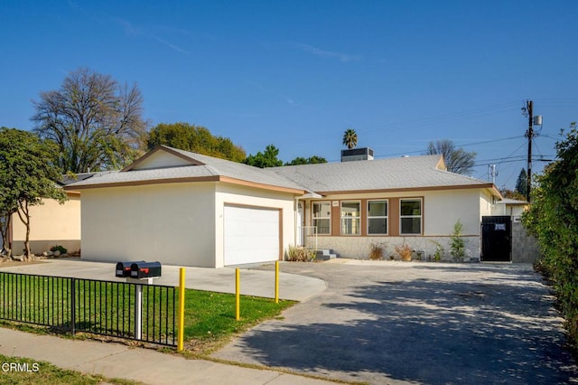 single story home featuring a garage and a front yard