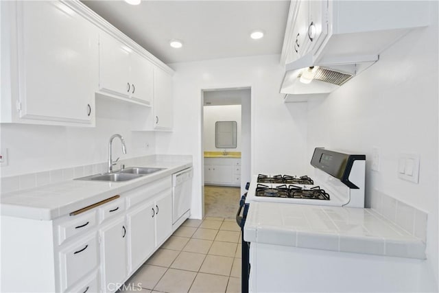 kitchen featuring white cabinetry, tile countertops, dishwasher, and sink