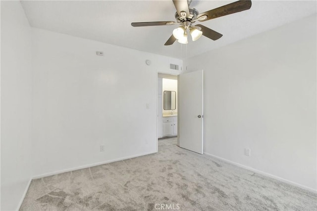 carpeted empty room featuring ceiling fan