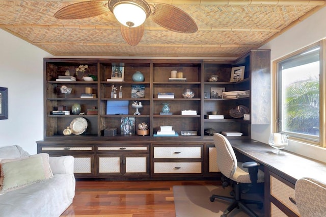 office space featuring built in desk and dark hardwood / wood-style flooring