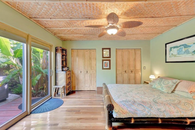 unfurnished bedroom featuring multiple closets, ceiling fan, light hardwood / wood-style floors, and access to outside