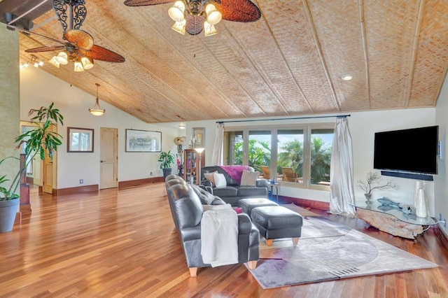 living room with hardwood / wood-style floors, high vaulted ceiling, and ceiling fan