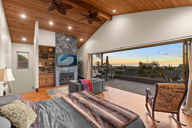 living room with beam ceiling, wood ceiling, high vaulted ceiling, hardwood / wood-style flooring, and a fireplace