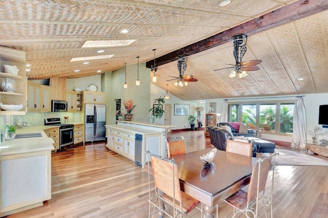 dining room featuring ceiling fan, sink, high vaulted ceiling, and light hardwood / wood-style flooring