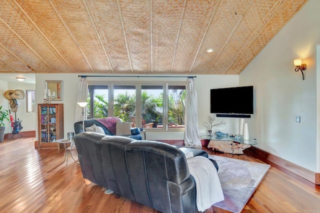 living room featuring hardwood / wood-style floors and vaulted ceiling