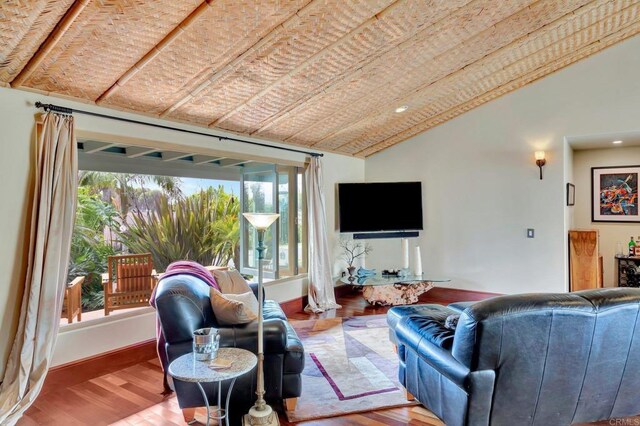 living room with lofted ceiling and wood-type flooring