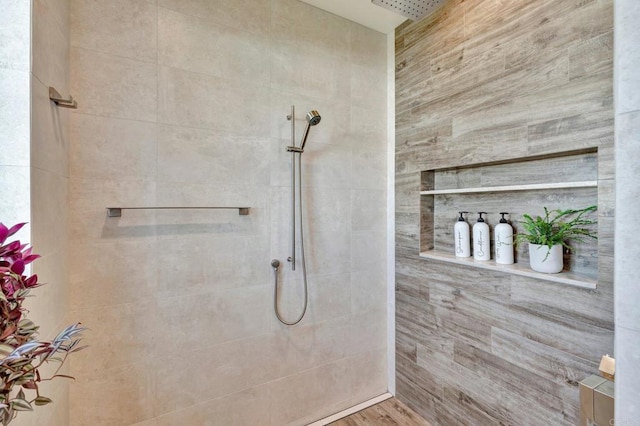 bathroom with a tile shower