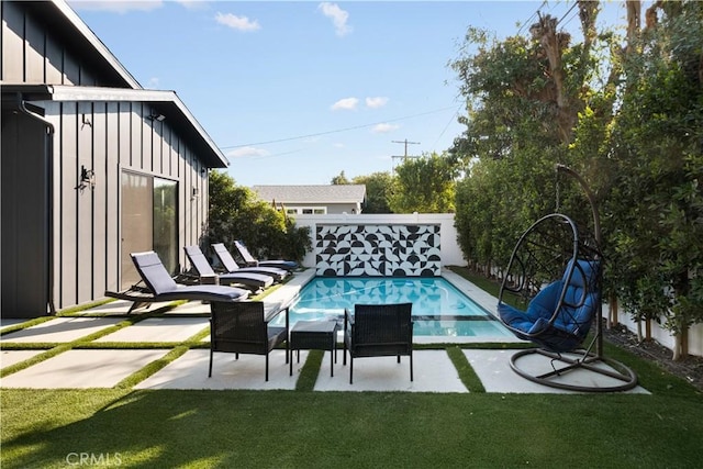 view of swimming pool with a patio area and a lawn