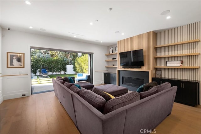 living room with a fireplace and light hardwood / wood-style floors