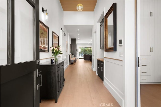 corridor with light hardwood / wood-style floors