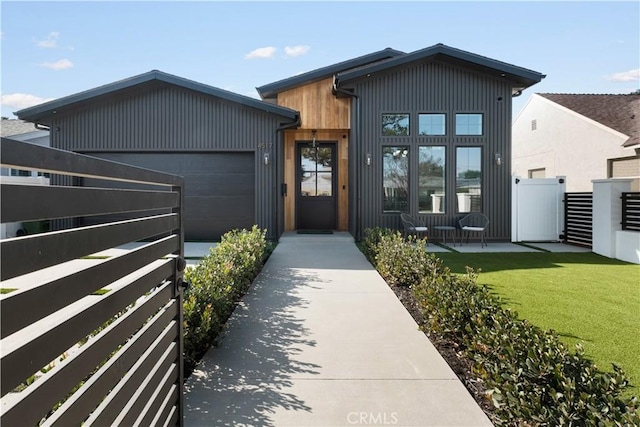 contemporary house with a garage and a front lawn