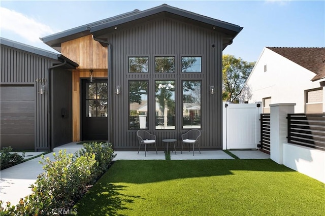 rear view of house featuring a lawn