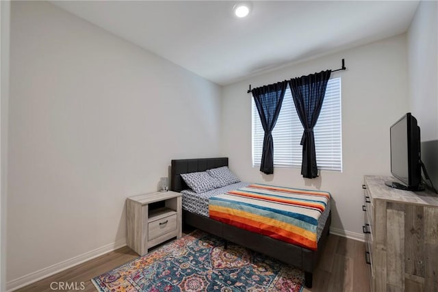 bedroom with dark wood-type flooring