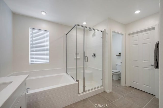 full bathroom featuring tile patterned flooring, vanity, independent shower and bath, and toilet