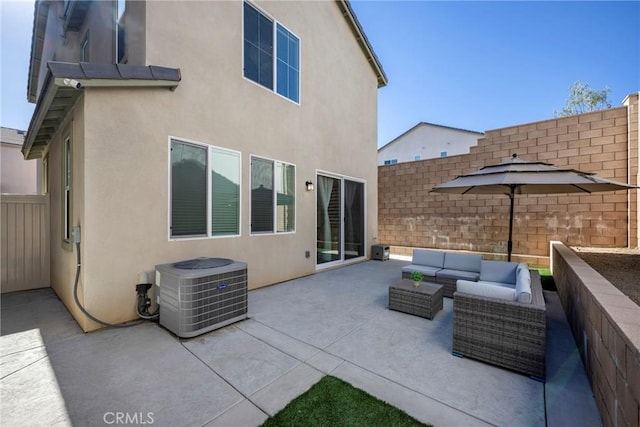 view of patio / terrace with central AC unit and an outdoor living space