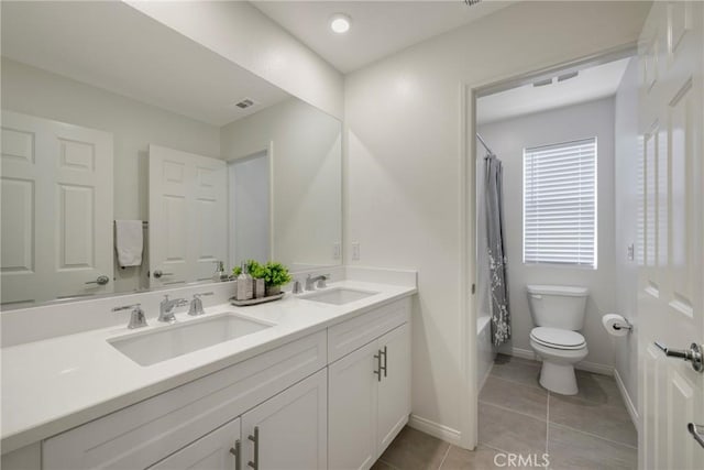 full bathroom featuring tile patterned floors, vanity, toilet, and shower / tub combo