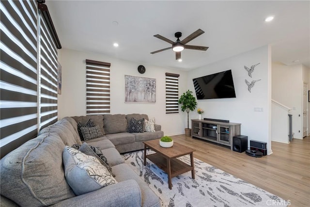 living room with ceiling fan and light wood-type flooring