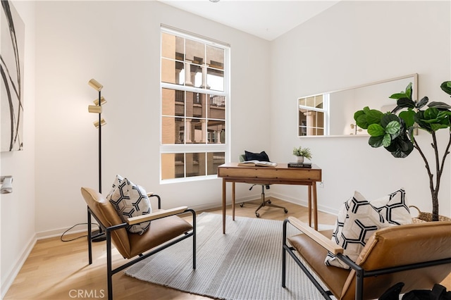 home office with light hardwood / wood-style floors