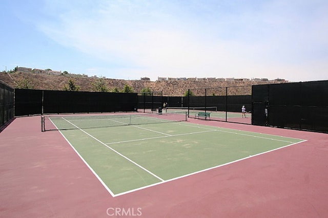 view of sport court with basketball hoop