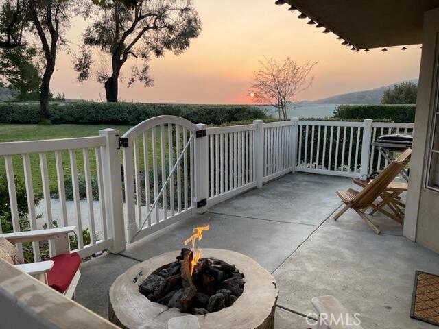 balcony at dusk with an outdoor fire pit