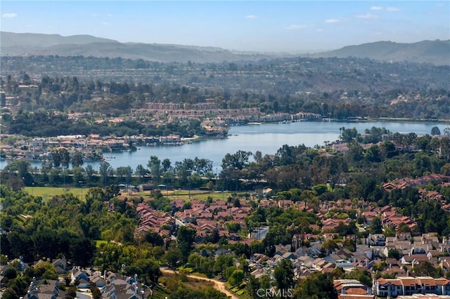 birds eye view of property featuring a water and mountain view