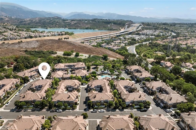 drone / aerial view featuring a water and mountain view