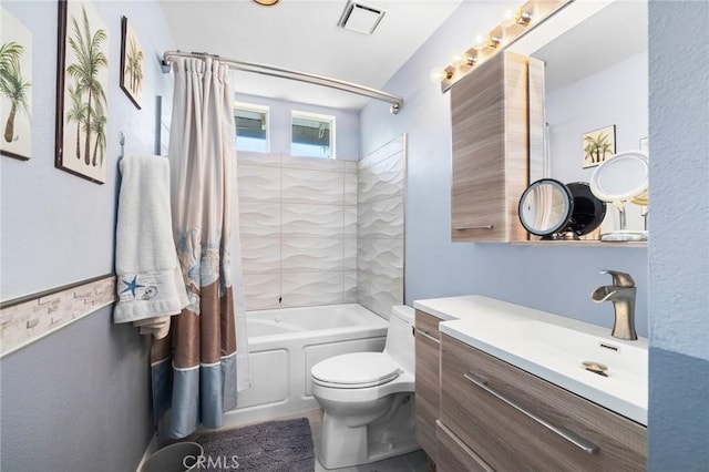 full bathroom with tiled shower / bath combo, vanity, and toilet