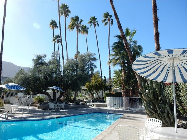 view of pool with a mountain view and a patio