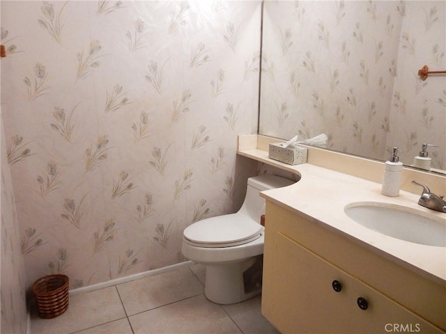 bathroom featuring vanity, tile patterned floors, and toilet