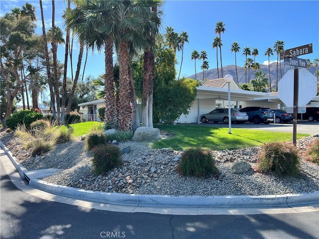 42278 Dunes View Rd Unit 28, Rancho Mirage, CA 92270 - view of front facade featuring a mountain view, a front lawn, and covered parking