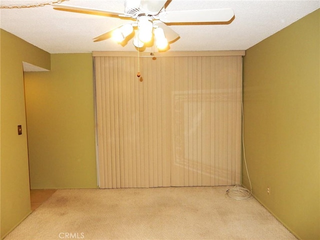 empty room with light carpet and ceiling fan