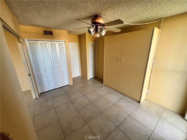 42278 Dunes View Rd Unit 28, Rancho Mirage, CA 92270 - unfurnished bedroom featuring light tile patterned floors, a ceiling fan, and a textured ceiling