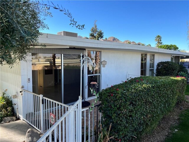 42278 Dunes View Rd Unit 28, Rancho Mirage, CA 92270 - view of side of home featuring a sunroom and stucco siding