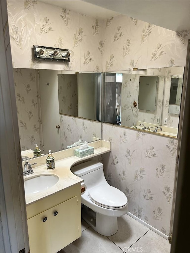 bathroom with vanity, tile patterned floors, and toilet