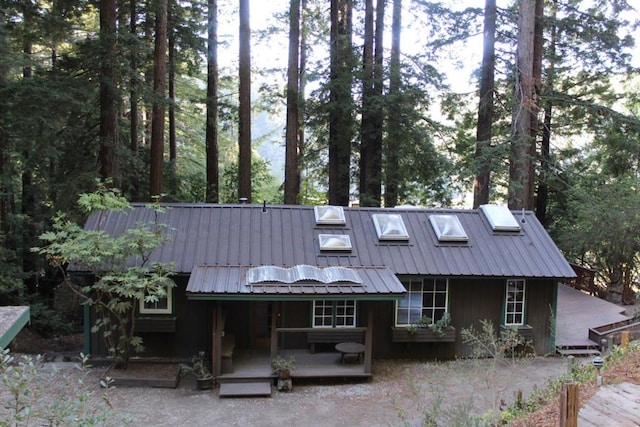 rear view of house featuring a wooden deck