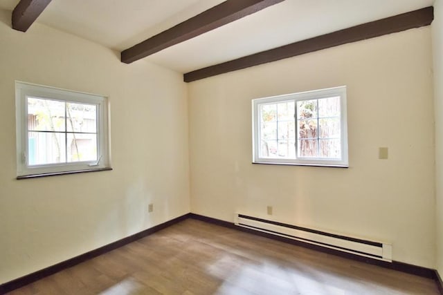 spare room with baseboard heating, beam ceiling, and wood-type flooring