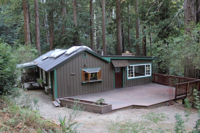 back of house featuring a wooden deck