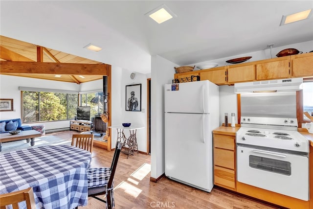 kitchen featuring light wood-type flooring, light brown cabinets, lofted ceiling with beams, and white appliances