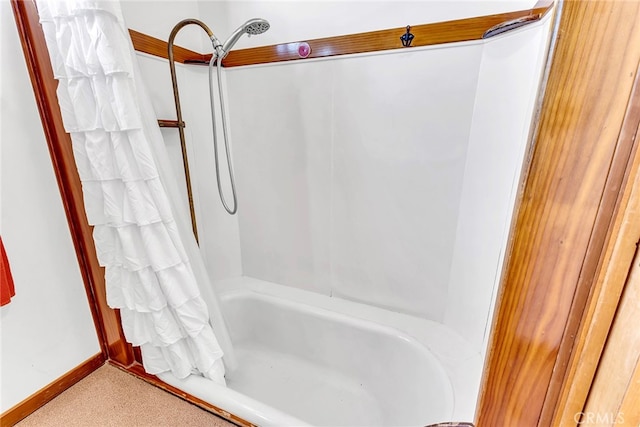 bathroom featuring shower / bathtub combination with curtain