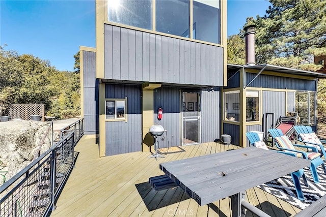 wooden terrace featuring a grill