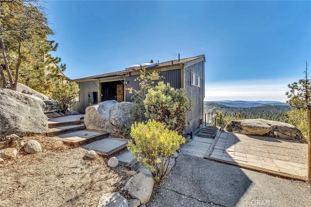 back of property featuring a mountain view