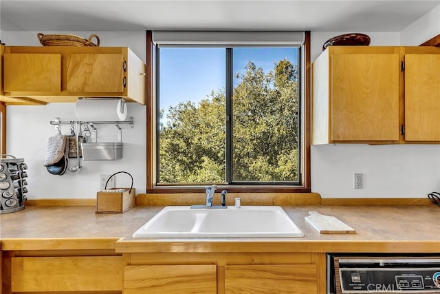 kitchen with sink, dishwasher, and tile countertops