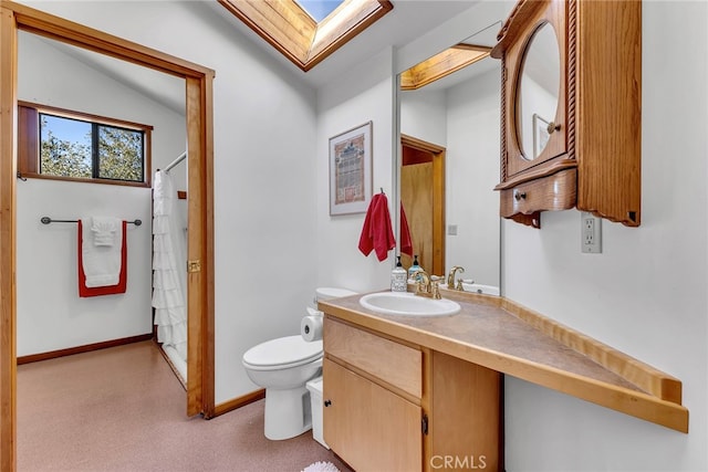 bathroom with toilet, vanity, a shower with curtain, and lofted ceiling with skylight