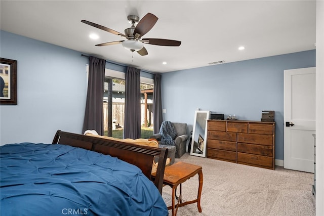 bedroom with ceiling fan and light carpet