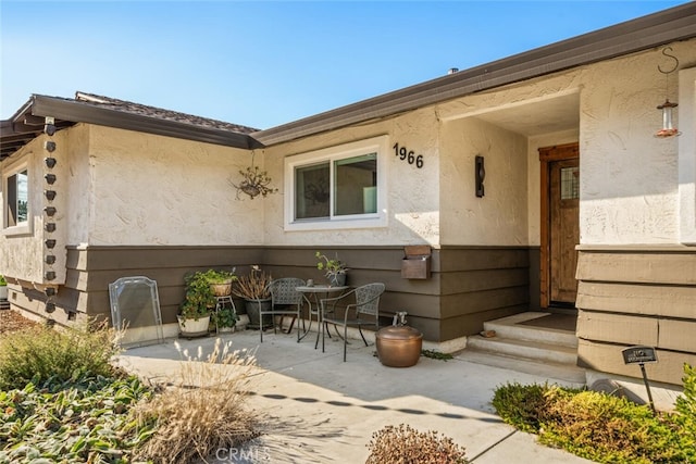 doorway to property with a patio