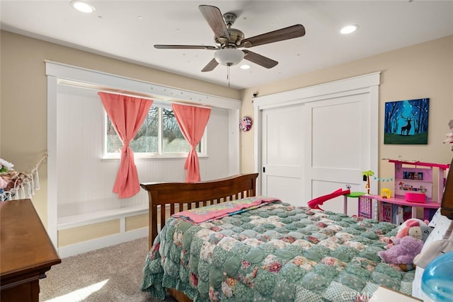 bedroom with ceiling fan, carpet, and a closet