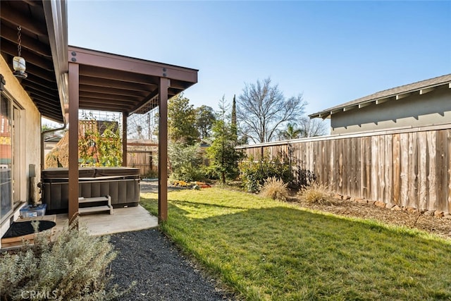 view of yard with a patio area and a hot tub