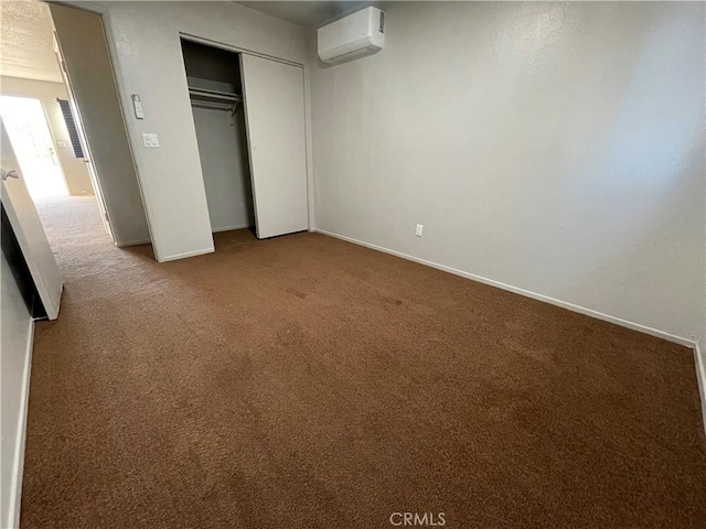 unfurnished bedroom with a closet, carpet, and a wall mounted air conditioner