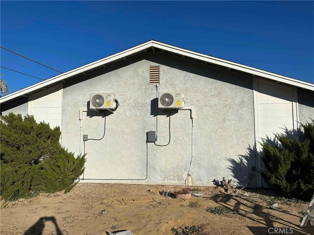 view of side of property featuring ac unit