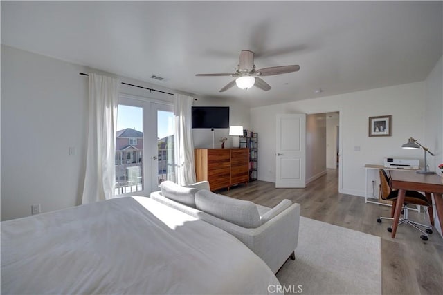 bedroom with ceiling fan, access to outside, light wood-type flooring, and french doors